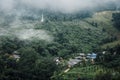 Buildings in mountain village. Foggy day, Top view village landscape Royalty Free Stock Photo