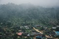 Buildings in mountain village. Foggy day, Top view village landscape Royalty Free Stock Photo