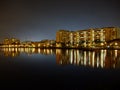 Buildings by Pandan reservoir under blue night sky