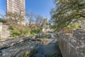 Buildings and pathways overlooking flowing water from the river into canals