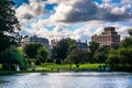 Buildings and a pond in the Public Garden in Boston, Massachusetts. Royalty Free Stock Photo