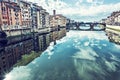 Buildings and Ponte Santa Trinita mirrored in river Arno, Florence, Italy Royalty Free Stock Photo