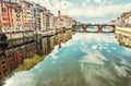 Buildings and Ponte Santa Trinita mirrored in river Arno, Florence, Italy Royalty Free Stock Photo