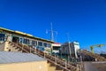 Buildings with radio towers on the pier with a gorgeous clear blue sky at the Santa Monica Pier