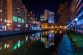 Buildings reflecting in the water at night in the Inner Harbor o Royalty Free Stock Photo