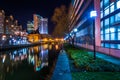 Buildings reflecting in the water at night in the Inner Harbor o Royalty Free Stock Photo