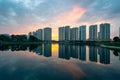 Buildings with reflections on lake at sunset at Thanh Xuan park. Hanoi cityscape at twilight period Royalty Free Stock Photo