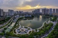 Buildings with reflections on lake at sunset at Thanh Xuan park. Royalty Free Stock Photo