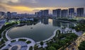 Buildings with reflections on lake at sunset at Thanh Xuan park.