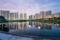 Buildings with reflections on lake at sunset at Thanh Xuan park. Hanoi cityscape at twilight period