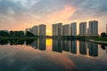 Buildings with reflections on lake at sunset at Thanh Xuan park. Hanoi cityscape at twilight period Royalty Free Stock Photo