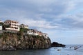 Buildings on the rocky coastline in a port of Camara de Lobos on Madeira Royalty Free Stock Photo