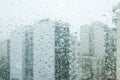 Buildings seen through a glass window full of water droplets Royalty Free Stock Photo