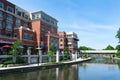 Buildings with Shops and Restaurants along the Naperville Riverwalk with a Covered Bridge in the Distance Royalty Free Stock Photo