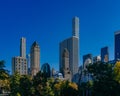 Buildings and skyscrapers of midtown Manhattan above trees, viewed from Central Park of New York City, USA Royalty Free Stock Photo