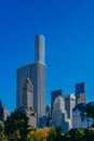 Buildings and skyscrapers of midtown Manhattan above trees, viewed from Central Park of New York City, USA Royalty Free Stock Photo