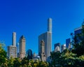 Buildings and skyscrapers of midtown Manhattan above trees, viewed from Central Park of New York City, USA Royalty Free Stock Photo