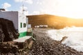 Buildings in small fishermen`s village with pebble beach