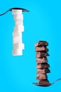 Buildings from sugar cubes and chocololate on a blue background Royalty Free Stock Photo