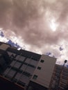 Buildings under thick grey clouds