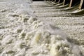 Buildup of white foam beneath a dam