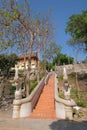 Dragon or naga balustrade and staircase leading up to Wat Maha Samanaram, an old Buddhist temple in Phetchaburi, Thailand