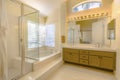 Built in bathtub and shower with glass door inside a beautiful bathroom