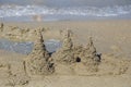 Built House sand castle with towers on the south shore of the sandy beach blue sea.