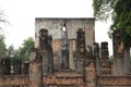 View of assembly hall viharn of Wat Si Chum & its Giant Buddha peering through the massive mondop wall, Sukhothai, Thailand