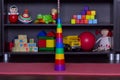 Built toy pyramid in the middle of the children playroom with toys indoor