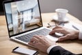 Buisiness man hand on table using a laptop with hotel room booking