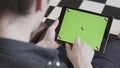 Buisnessman show a tablet green screen in back view when using gatget. Stock footage. Businessman working at home on