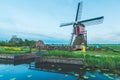 Buitenwegse Molen shot in a green field next to a stream under a blue sky located in Oud-Zuilen Royalty Free Stock Photo