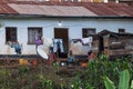 African family sitting in front of their house on the boarder of Rwanda a