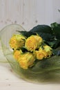 Buket of yellow roses, on a wooden table. Royalty Free Stock Photo