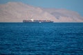 Bukha, OMAN - MAY 28 2021: Iranian coastline near the Strait of Hormuz. giant sea container ship in the strait of Hormuz Royalty Free Stock Photo