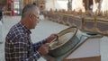 Bukhara master engraves patterns on a tray.