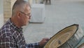 Bukhara master engraves patterns on a tray.