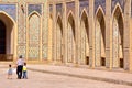 BUKHARA, UZBEKISTAN - MAY 9, 2011: An Uzbek man with his two children walking in the courtyard of the Poy Kalon mosque