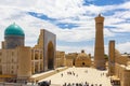 Bukhara - a view on the square at the Kalyan Minaret and Mosque with groups of tourists Royalty Free Stock Photo