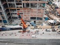 Bukit Bintang, Malaysia - July 27, 2019: View from above, stunning aerial view of a construction site with workers on cranes next Royalty Free Stock Photo