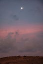 Bukit Merese Twilight: Pinkish Blue Sky, Moon, and People Amidst Lombok\'s Serenity