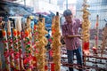 A man insert the dragon joss stick into hole.