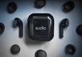 Top view of black Sudio Nio earphones in a case