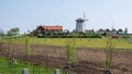 Bukovany, Czech Republic / Southern Moravia - April 18, 2020: Bukovany wind mill and orchard with field