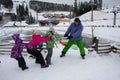 Bukovel, Ukraine - December 26, 2018. Little girls have fun on the snow slides of a frozen mountain lake and enjoy the fresh snow