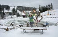 Bukovel, Ukraine - December 26, 2018. Little girls have fun on the snow slides of a frozen mountain lake and enjoy the fresh snow