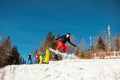 Bukovel, Ukraine - December 22, 2016: Man boarder jumping on his snowboard against the backdrop of mountains, hills and Royalty Free Stock Photo