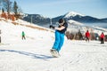 Bukovel, Ukraine - December 22, 2016: Man boarder jumping on his snowboard against the backdrop of mountains, hills and Royalty Free Stock Photo