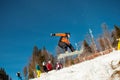 Bukovel, Ukraine - December 22, 2016: Man boarder jumping on his snowboard against the backdrop of mountains, hills and Royalty Free Stock Photo